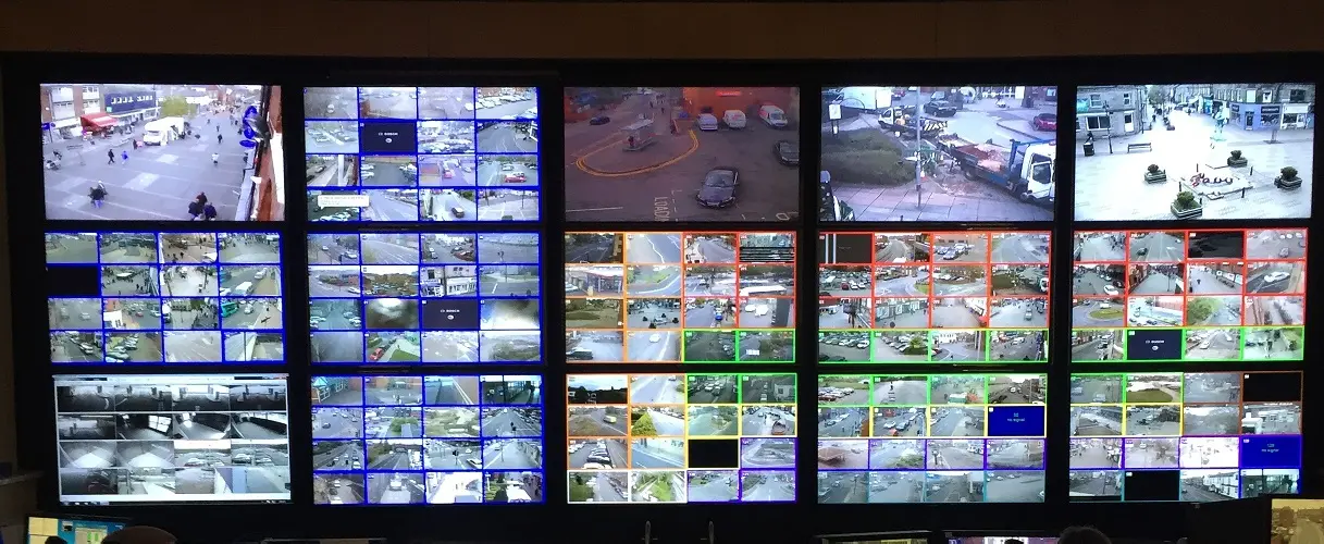 CCTV control-room monitor wall displaying many camera views