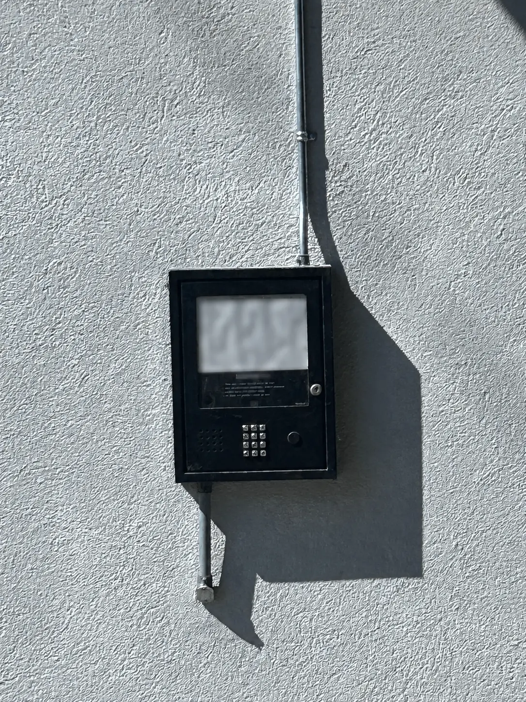 Privacy-edited before photo of the old Carlton Court audio intercom in Surrey with every resident directory name blurred