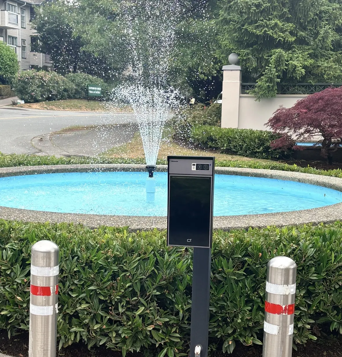 Akuvox S539 video intercom on a pedestal beside the Chelsea Gardens entrance fountain in Surrey