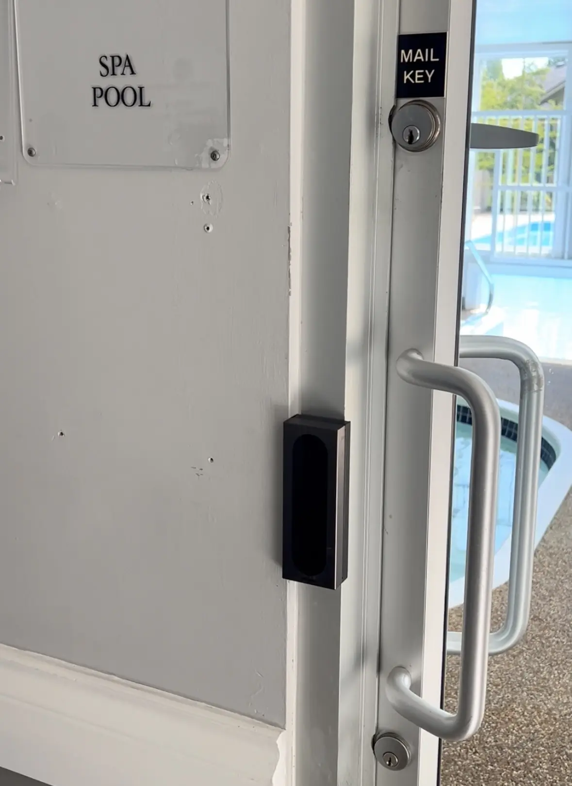 Akuvox A08 access-control reader beside the Chelsea Gardens pool and spa amenity door in Surrey