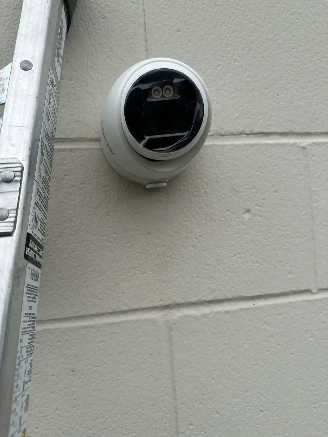 Close-up of a Hikvision camera at DRIVE Basketball with cabling concealed behind the mount