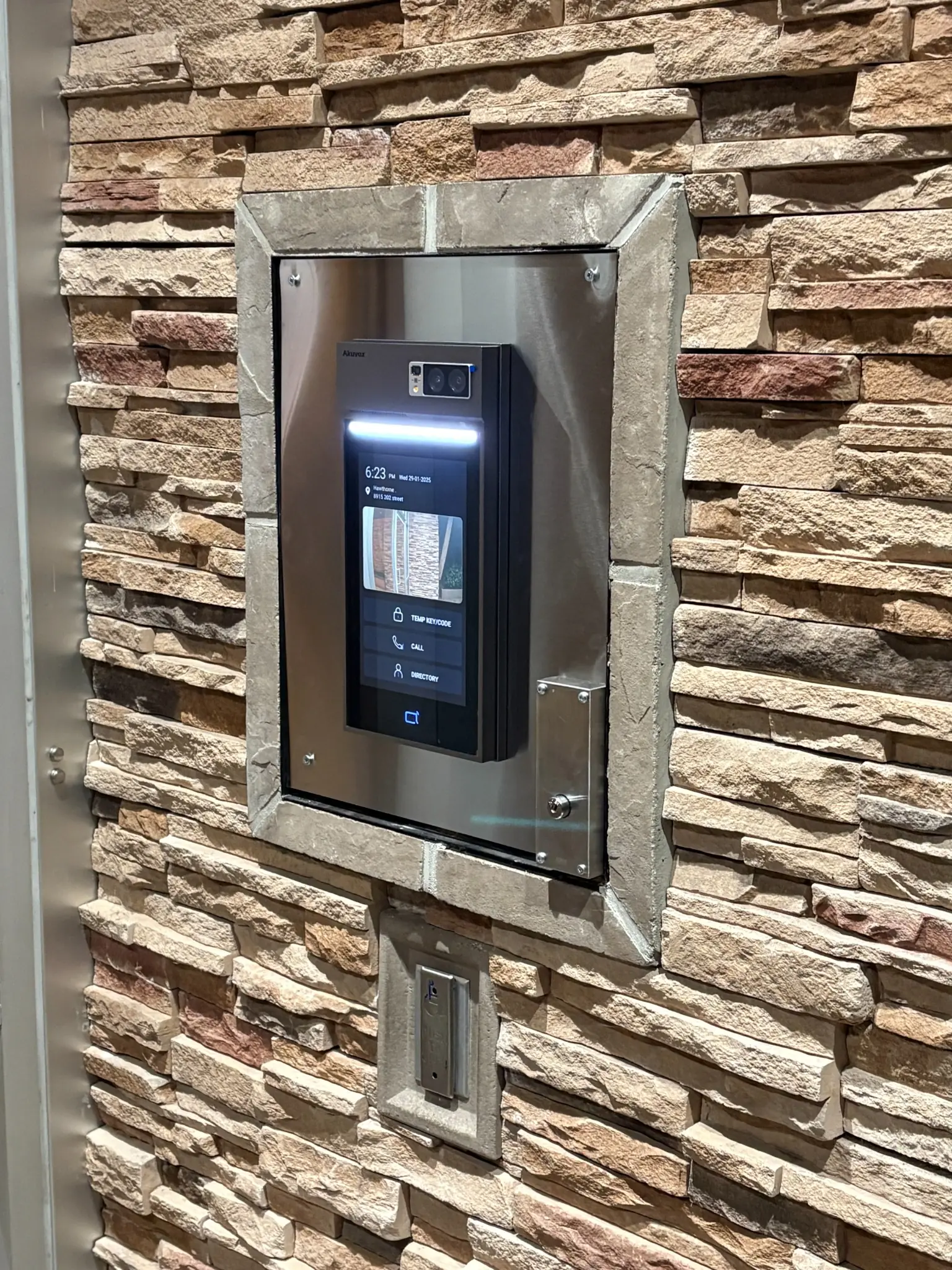 After photo of the Akuvox S539 video intercom on a custom stainless-steel retrofit plate at Hawthorne in Langley
