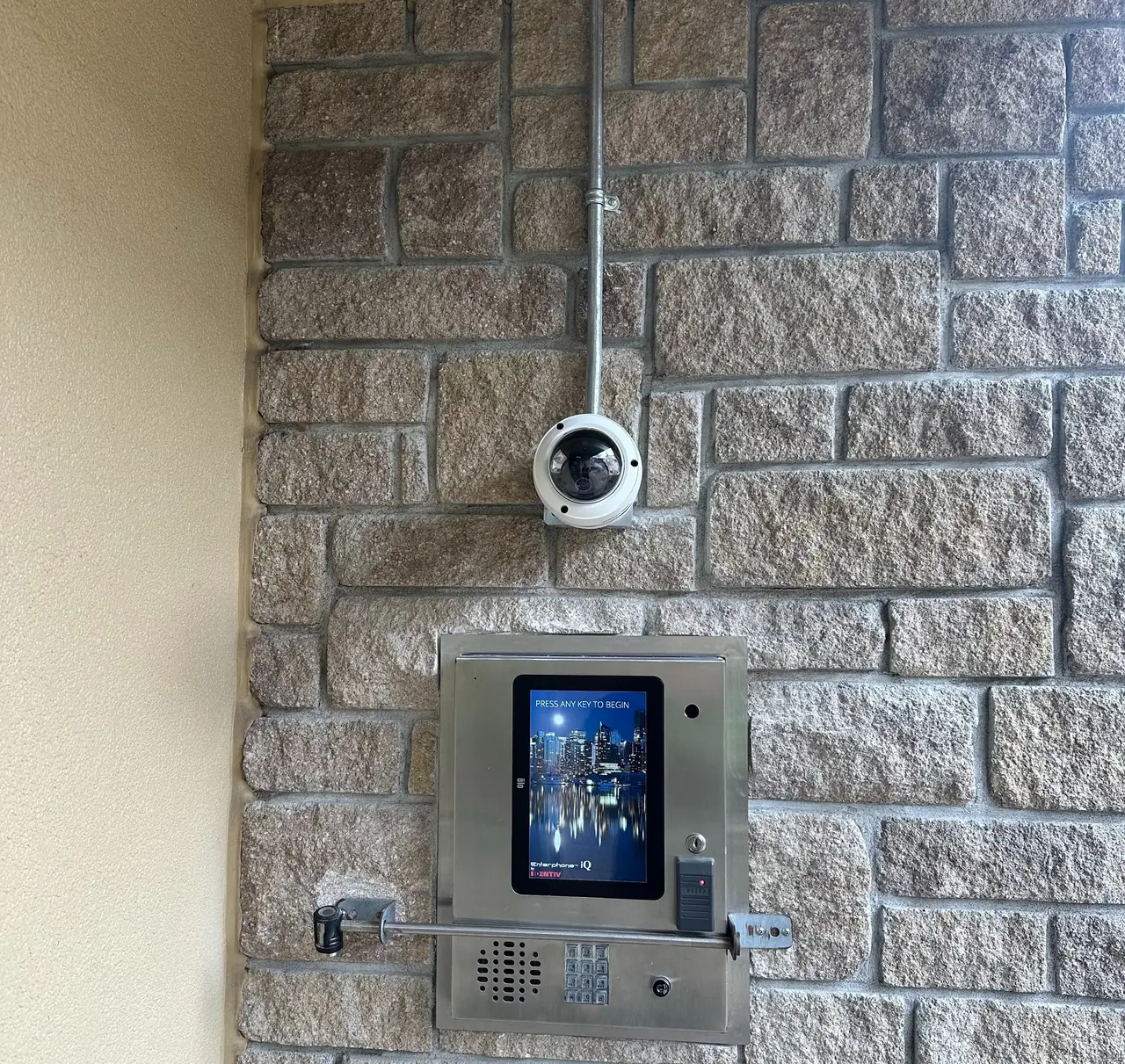Hikvision dome security camera installed above the existing entrance intercom at Shearwater Residences in White Rock