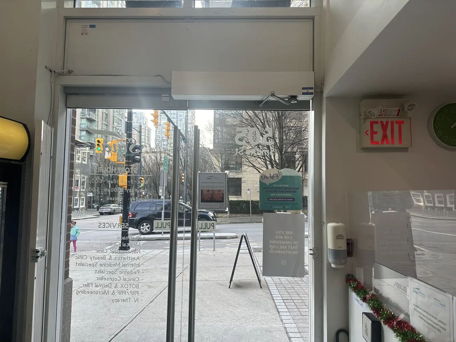 Automatic door operator installed by WeTech above the entrance at Sina Pharmacy in downtown Vancouver