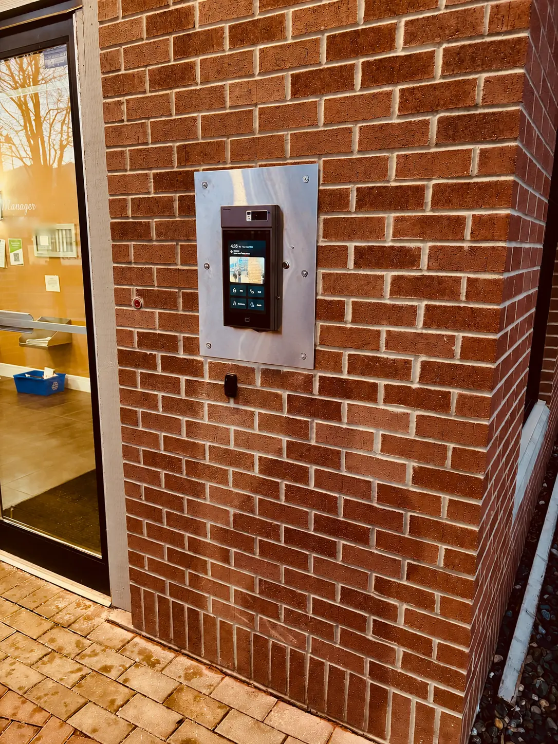 After photo of the Akuvox video intercom on a stainless-steel retrofit plate at Thurston Apartments in Chilliwack